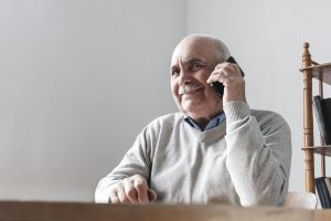 Happy senior man chatting on his mobile phone